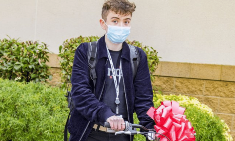 Photo of young man delivering a free secondhand bike