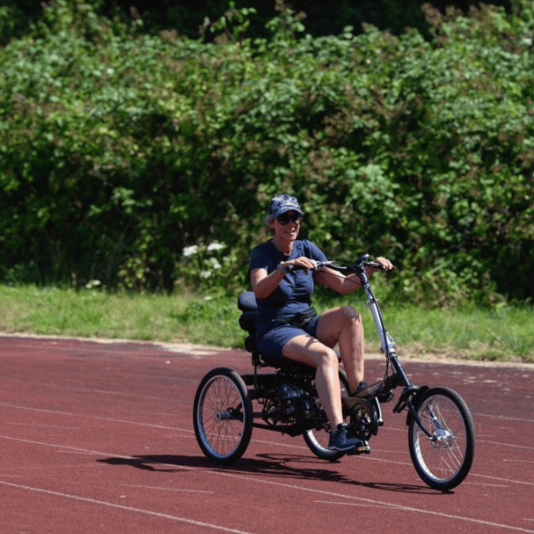Adult tiding an adapted bike around the cycle centre circuit