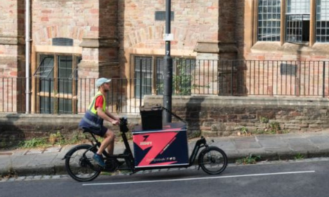 Cargo bike cycling up steep hill doing deliveries