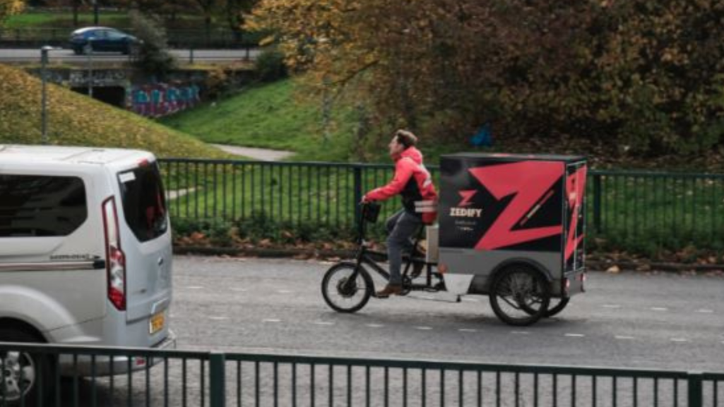 man cycling on a cargo bike doing deliveries