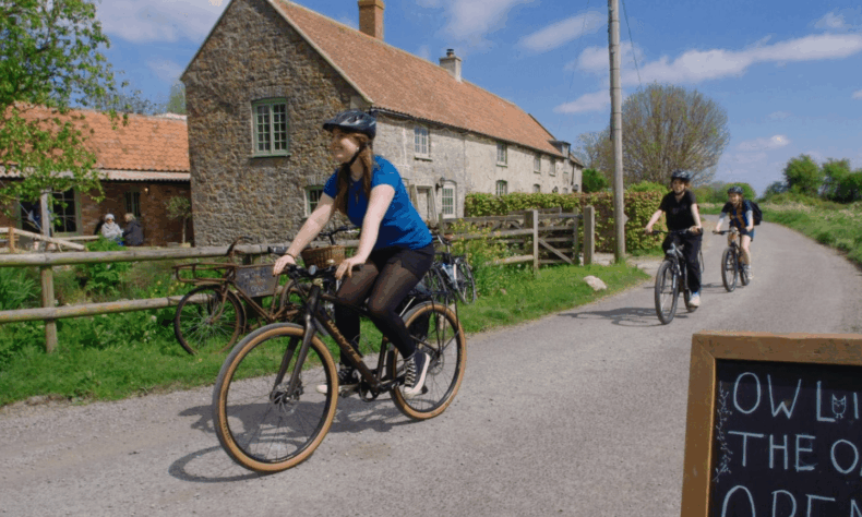 Woman cycling on a country lane in North Somerset